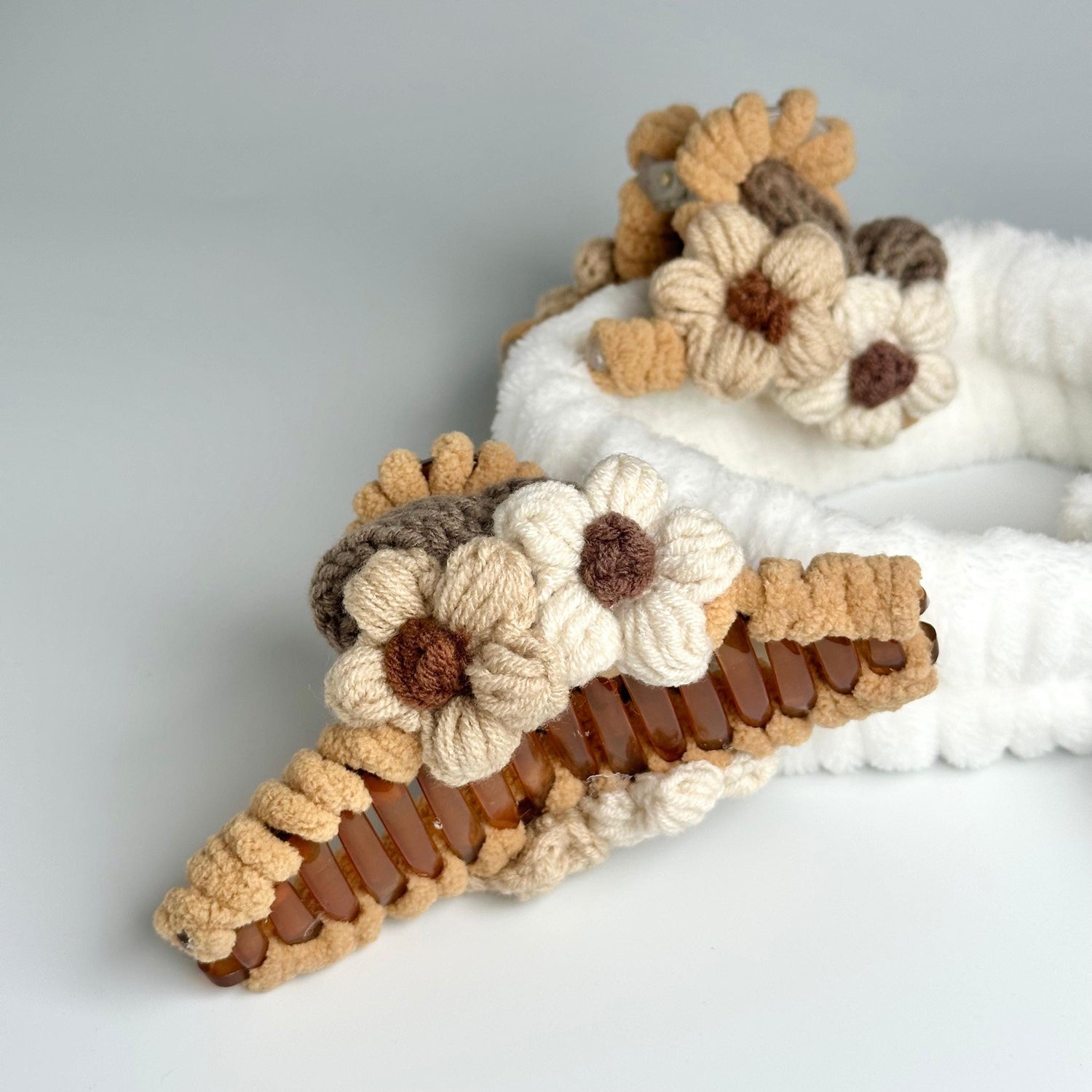 a pair of crocheted slippers with flowers on them