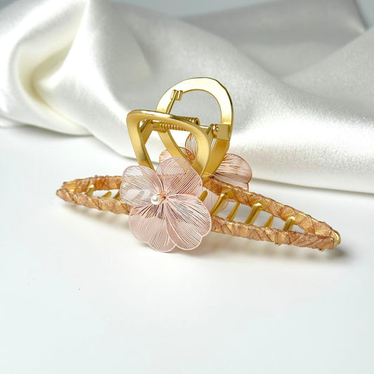 a gold ring with a flower on top of it