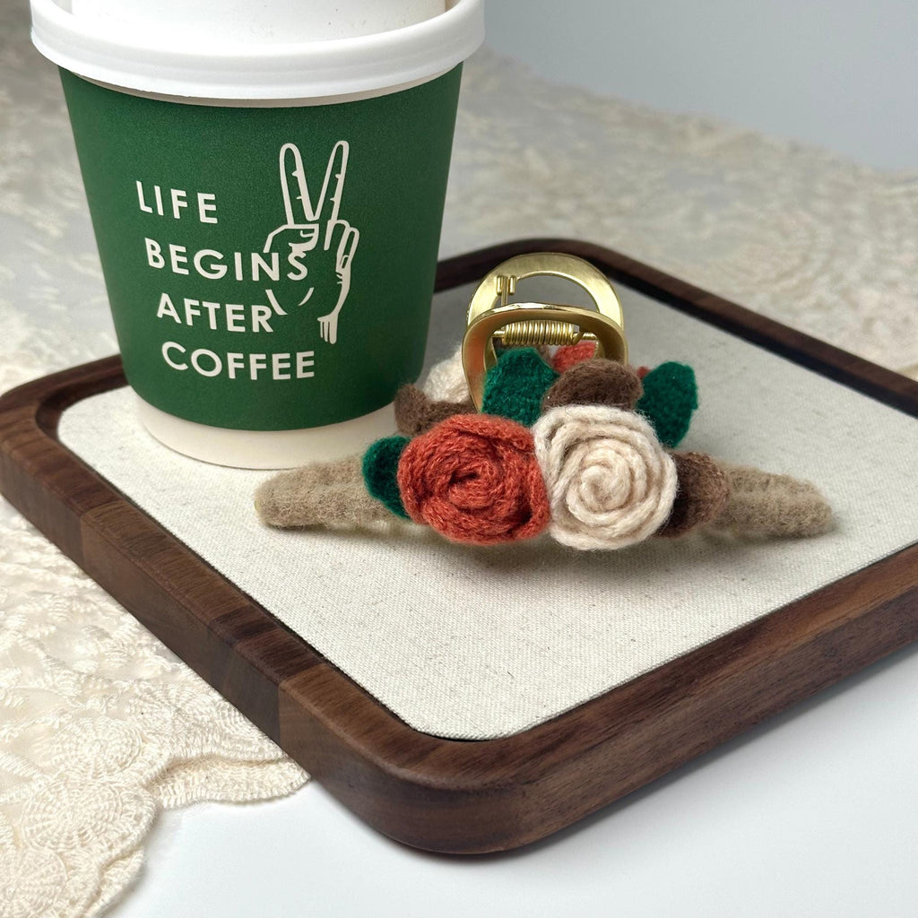a coffee cup with a ring and a flower on a tray