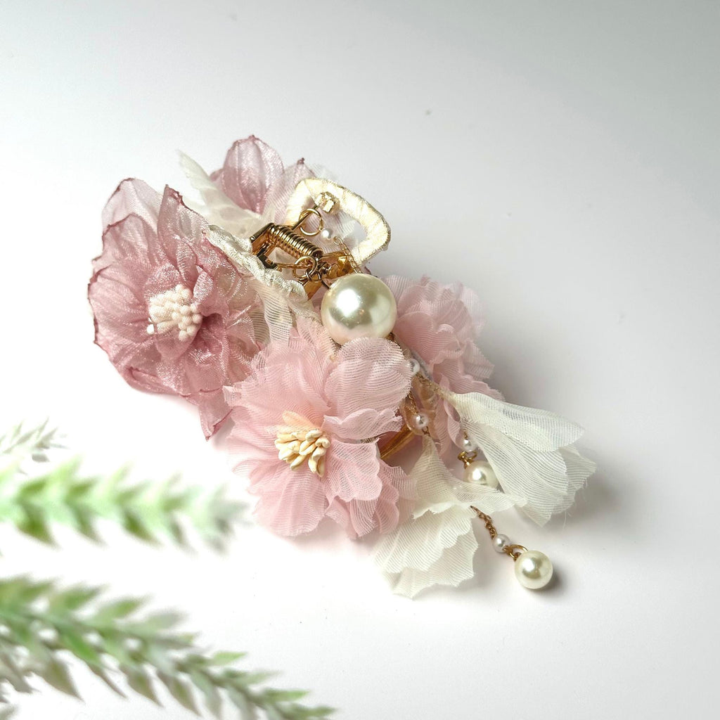 a bouquet of flowers with pearls and pearls