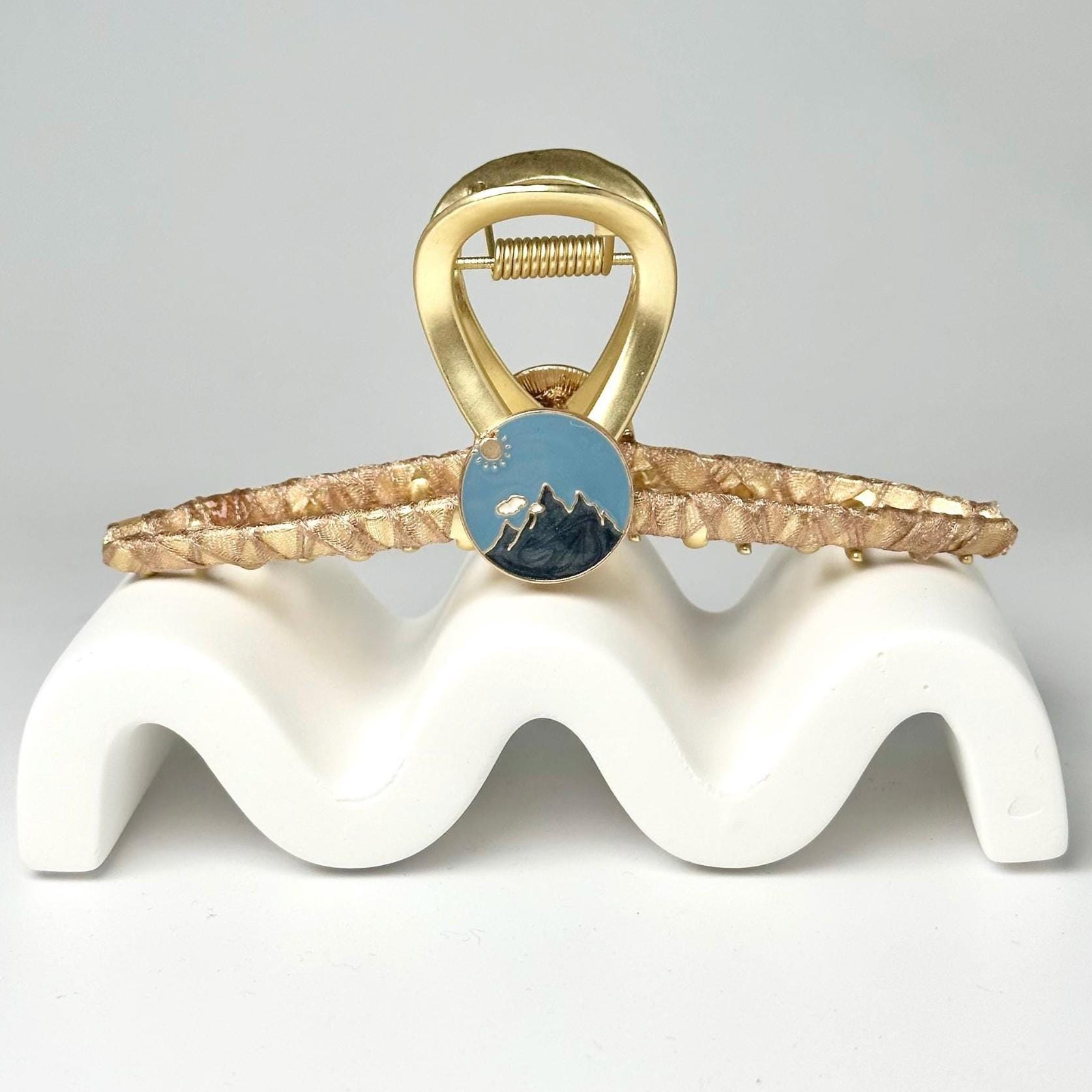 a gold ring with a blue stone on it