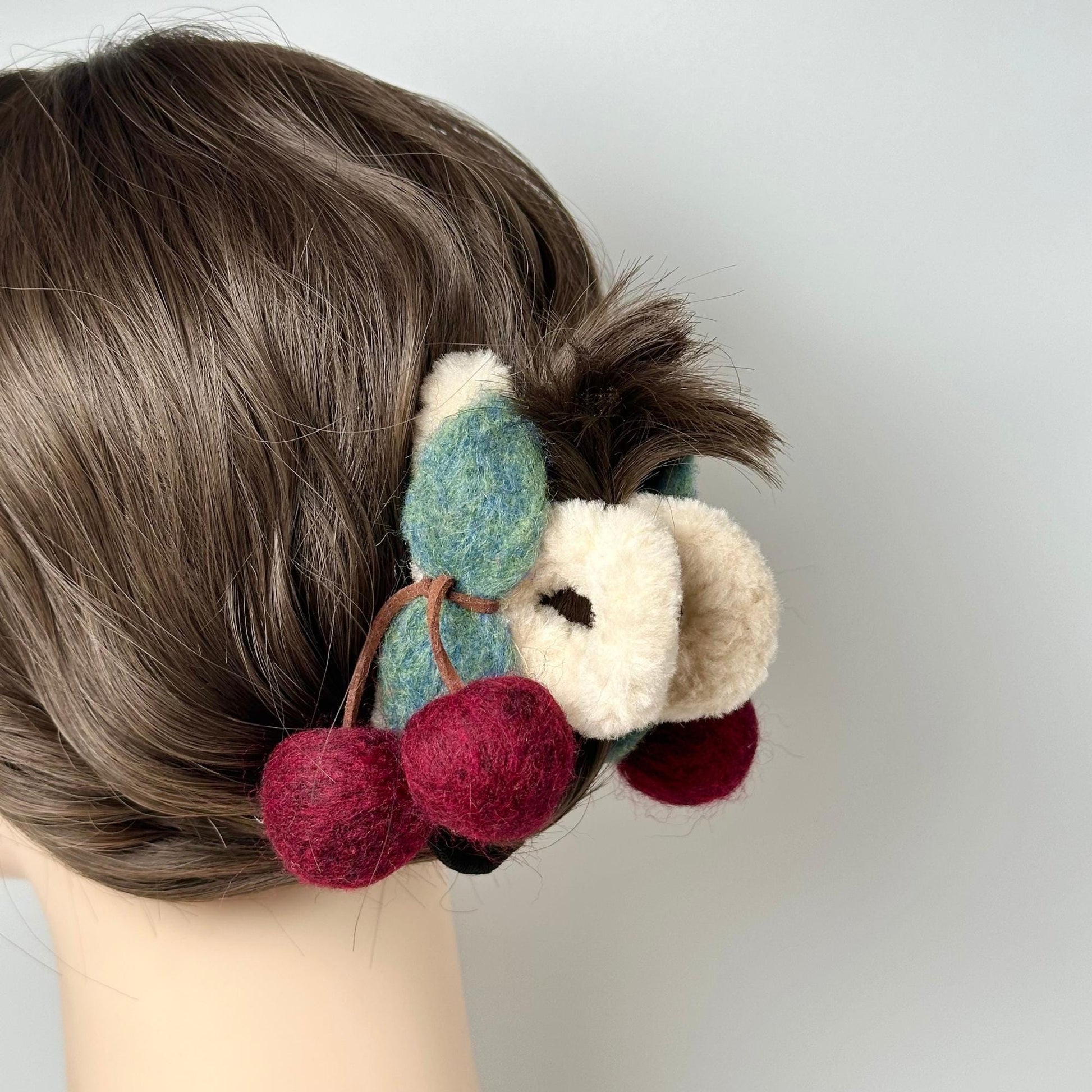 a close up of a person&#39;s hair with a stuffed animal in it