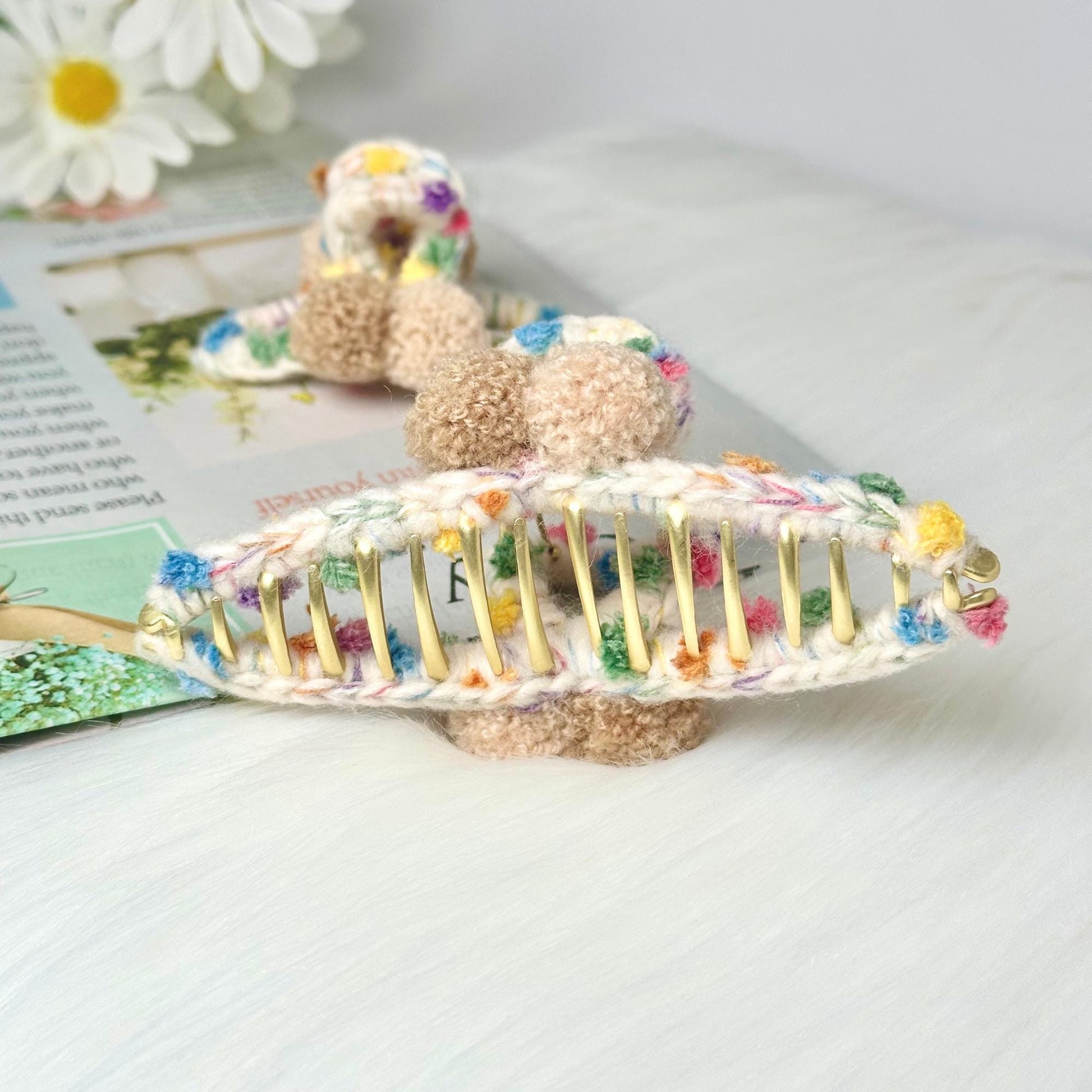 a crocheted hair comb with a teddy bear on top of it