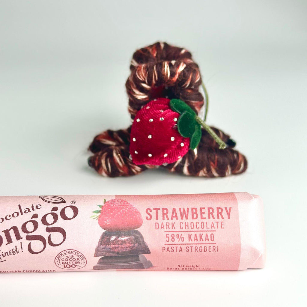a chocolate bar with a strawberry on top of it