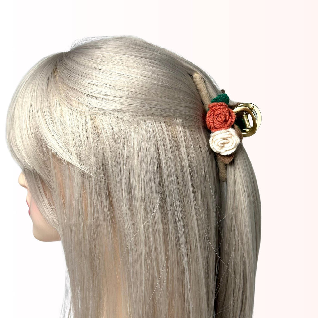a woman with blonde hair and a flower in her hair