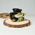 a pair of sunglasses sitting on top of a piece of wood
