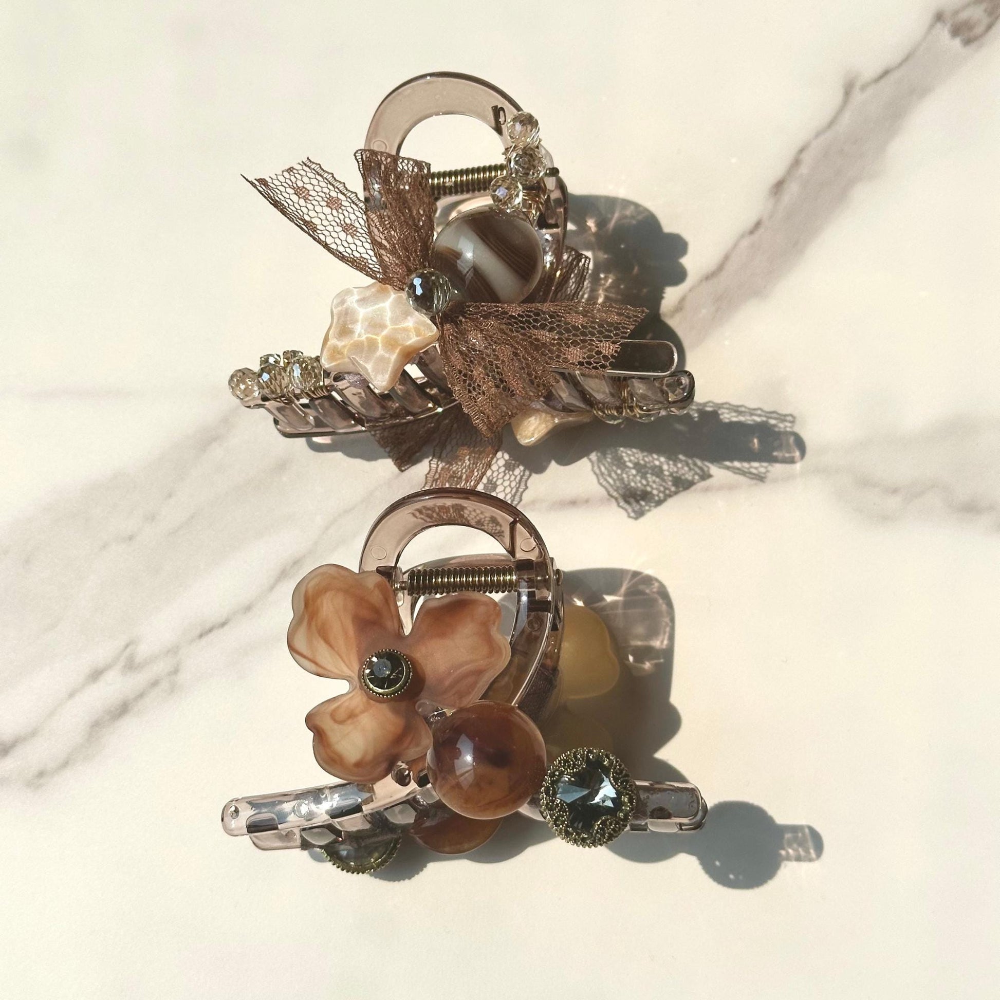 a close up of two brooches on a table