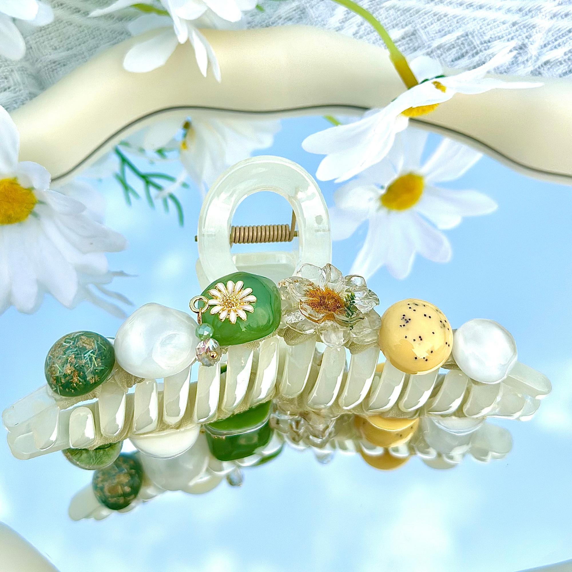 Large Daisy Floral Hair Claw Clip by Ms. Pepper's Closet. Perfect for thick hair, this large floral design securely holds hair in place. Ideal for those seeking stylish cute claw clips.