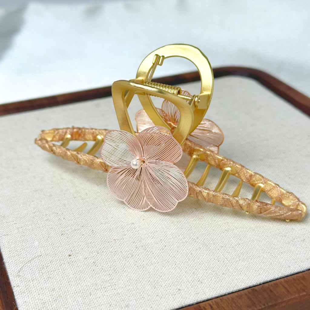 a close up of a brooch with a flower on it