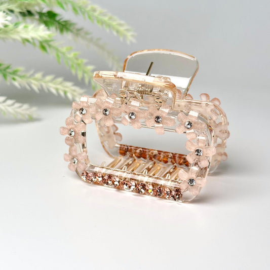 a pink and gold ring sitting on top of a white table