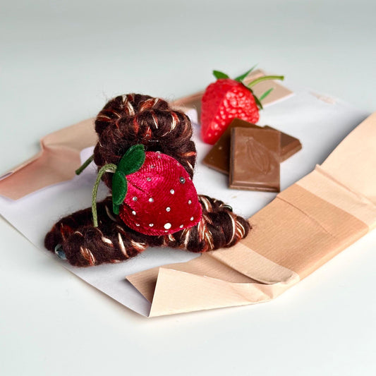 a piece of brown paper with a strawberry on top of it