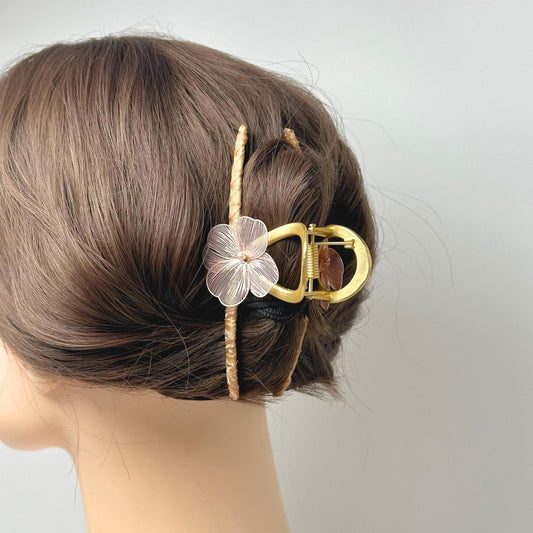 a close up of a hair piece with a flower on it