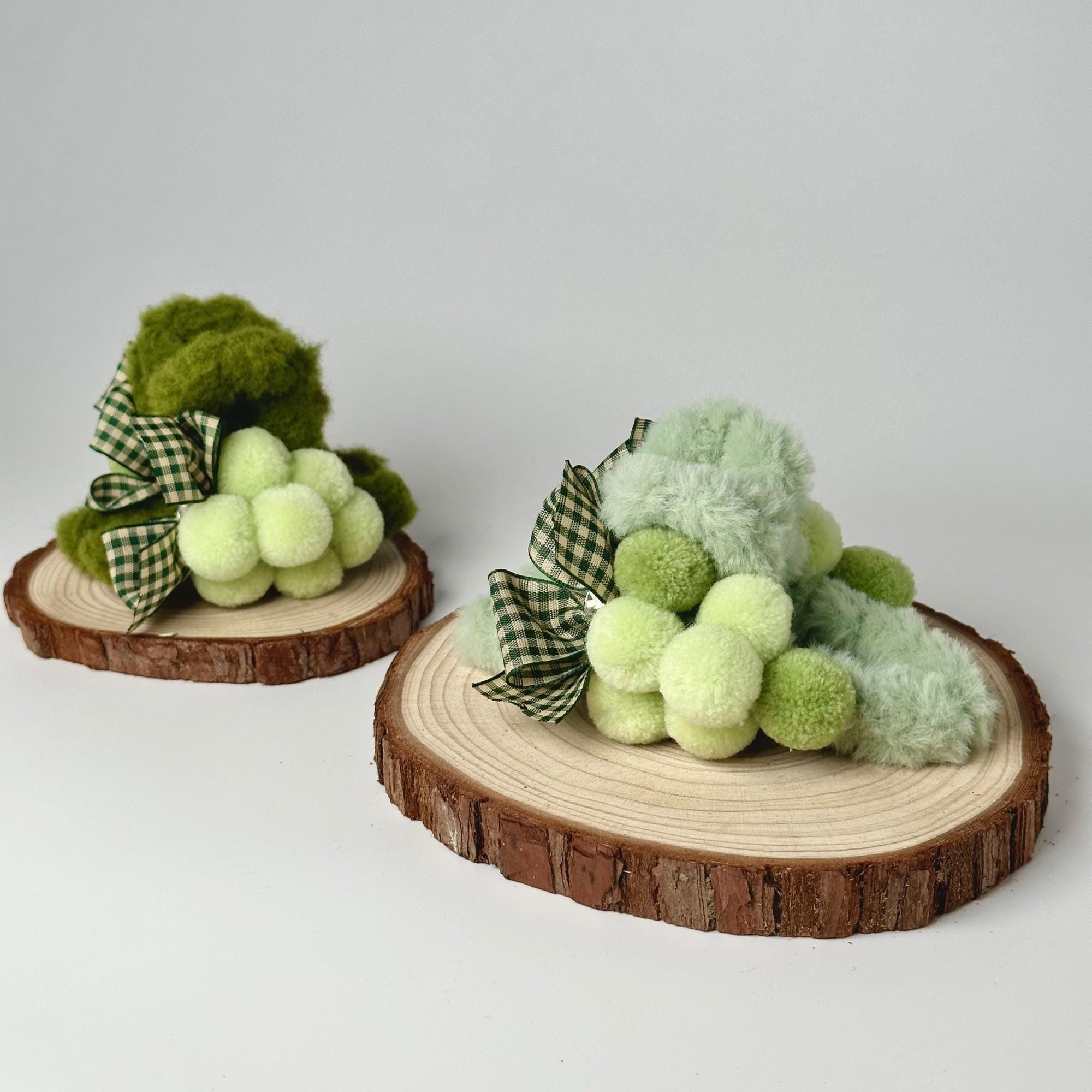 a couple of small stuffed animals sitting on top of a tree stump