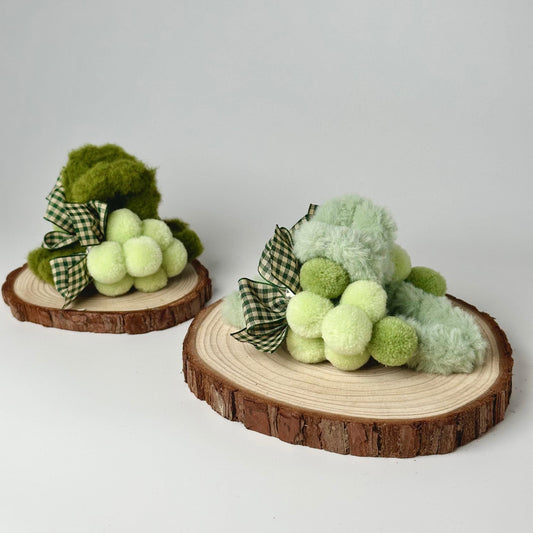 a couple of small stuffed animals sitting on top of a tree stump