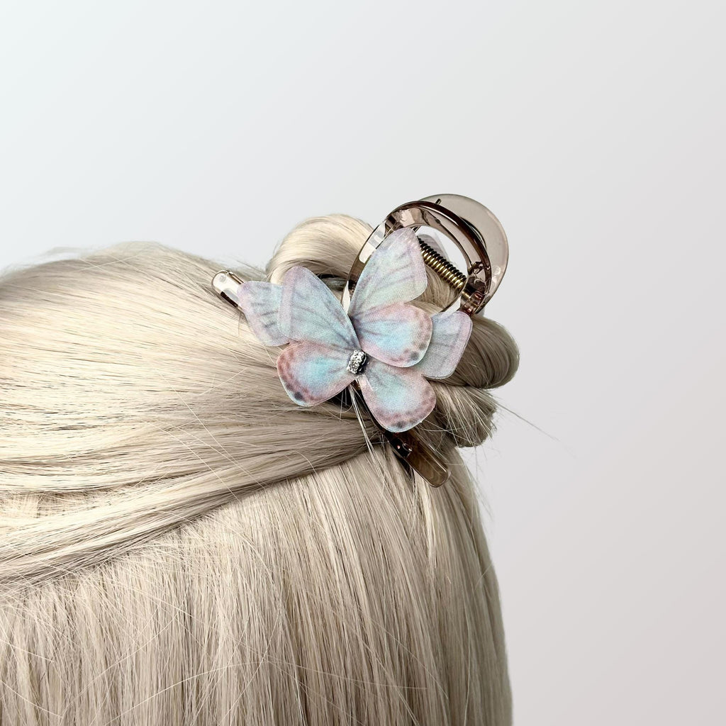a close up of a hair with a butterfly on it