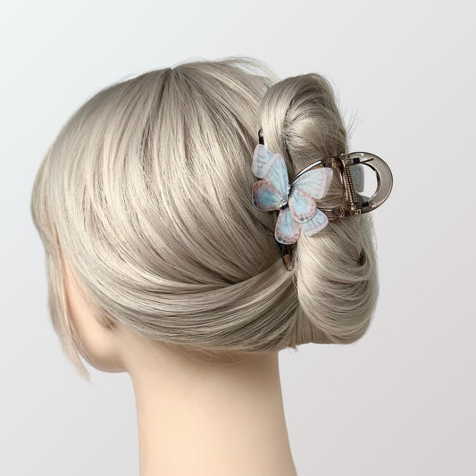 a woman&#39;s head with a hair clip in the shape of a butterfly