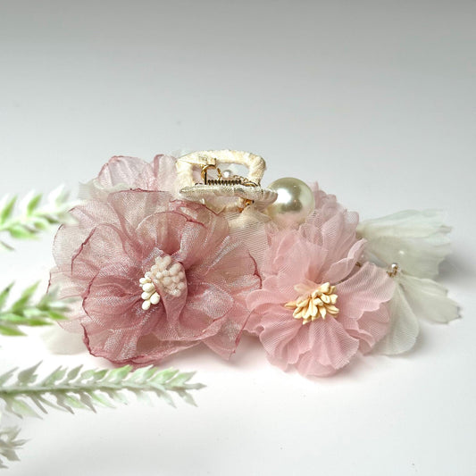 a pair of pink flowers with pearls on them