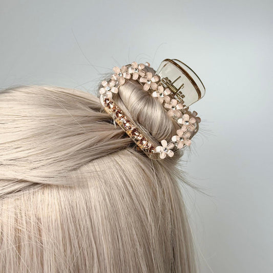 a woman with blonde hair wearing a hair clip